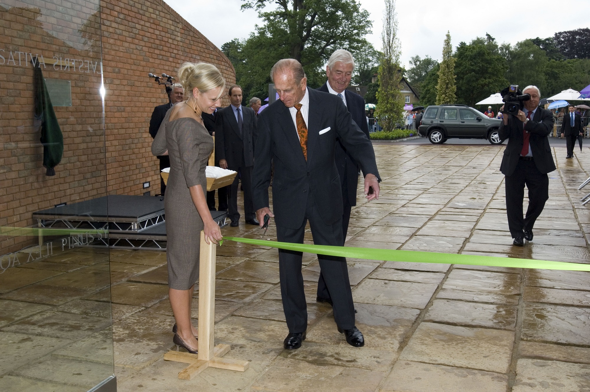 The Duke of Edinburgh cutting a ribbon outside the The Savill Building.