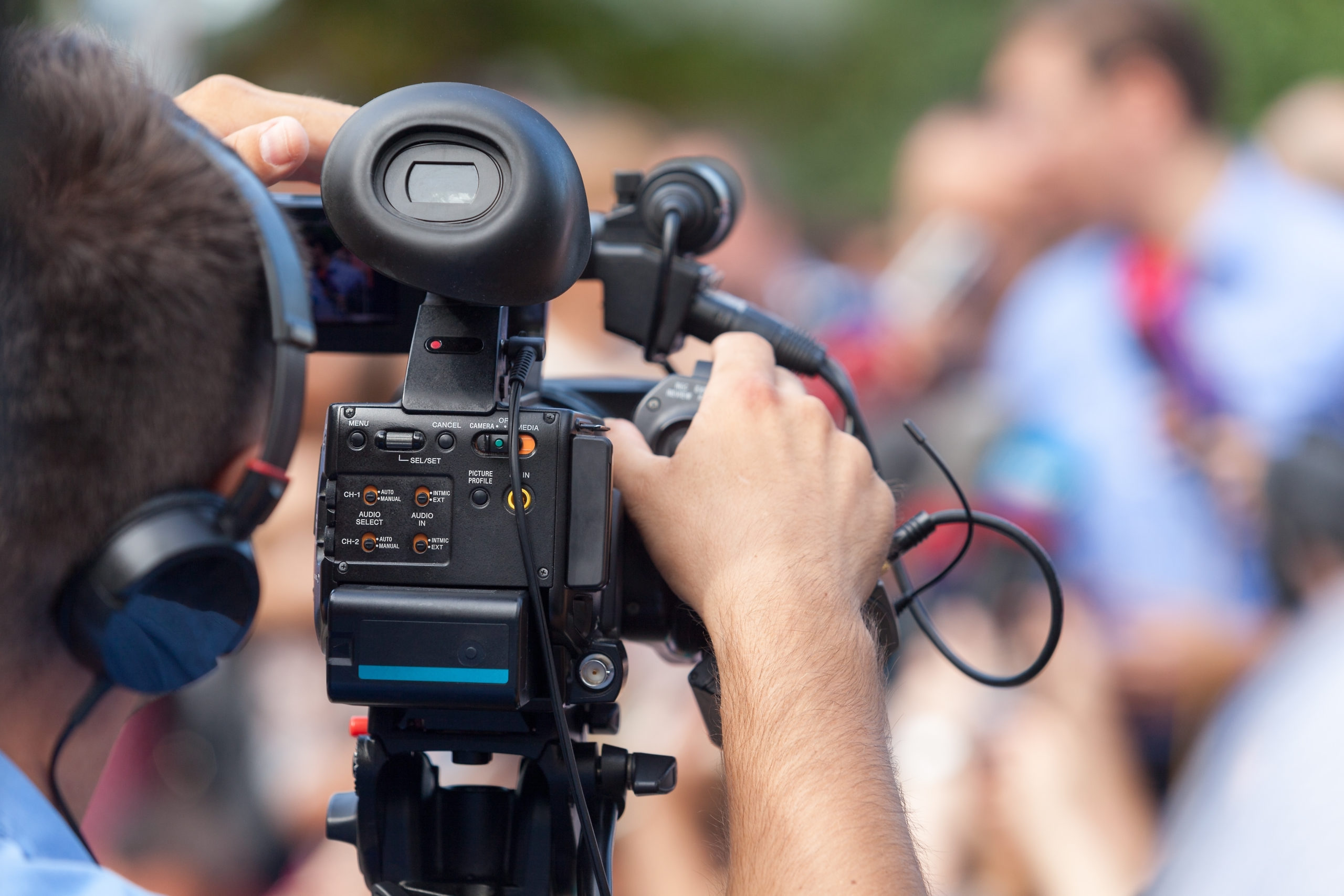 A person operating a video camera.