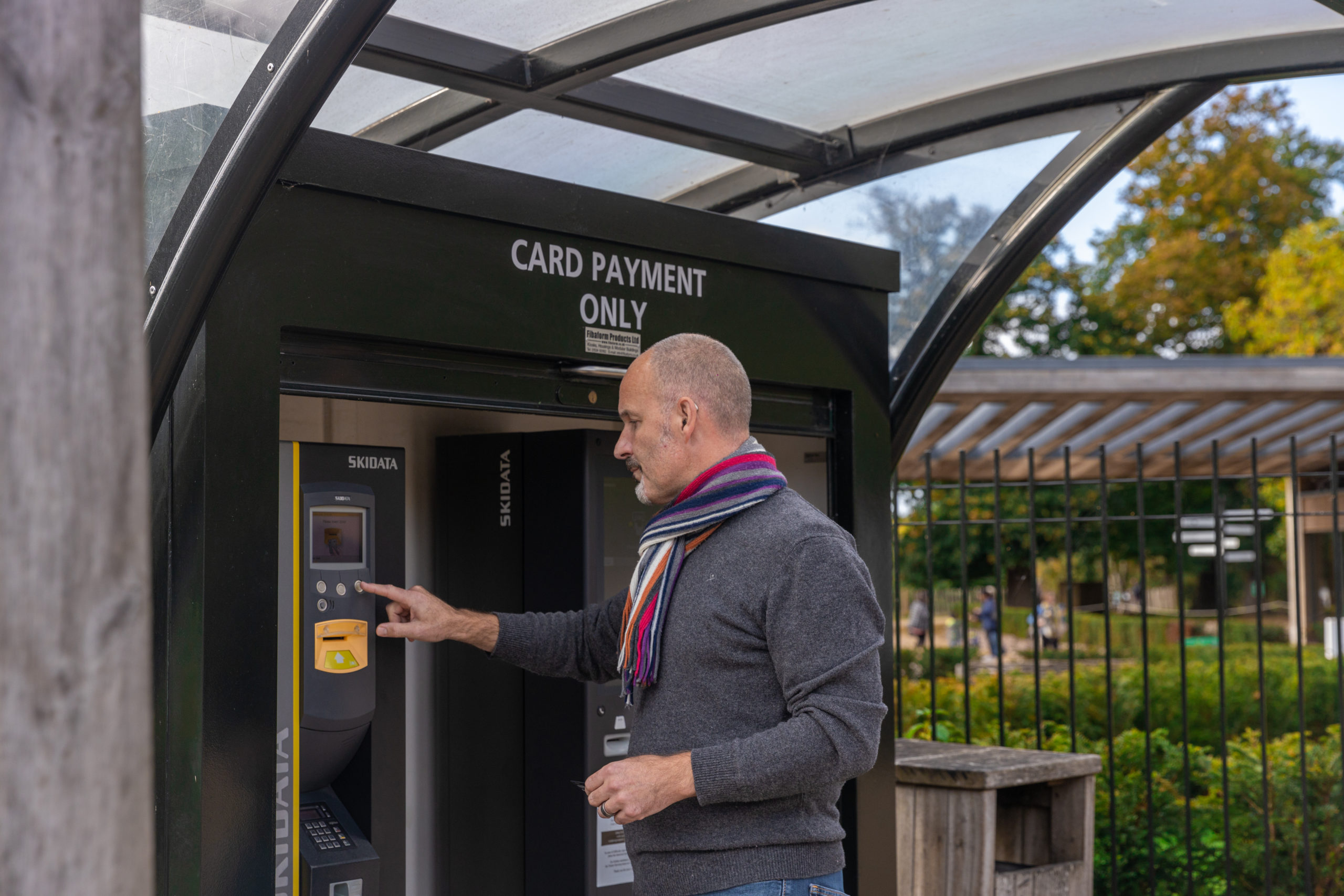 Adult at the car park card payment machine.