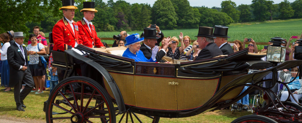 Queen Elizabeth II and The Duke of Edinburgh in a horse drawn carriage.