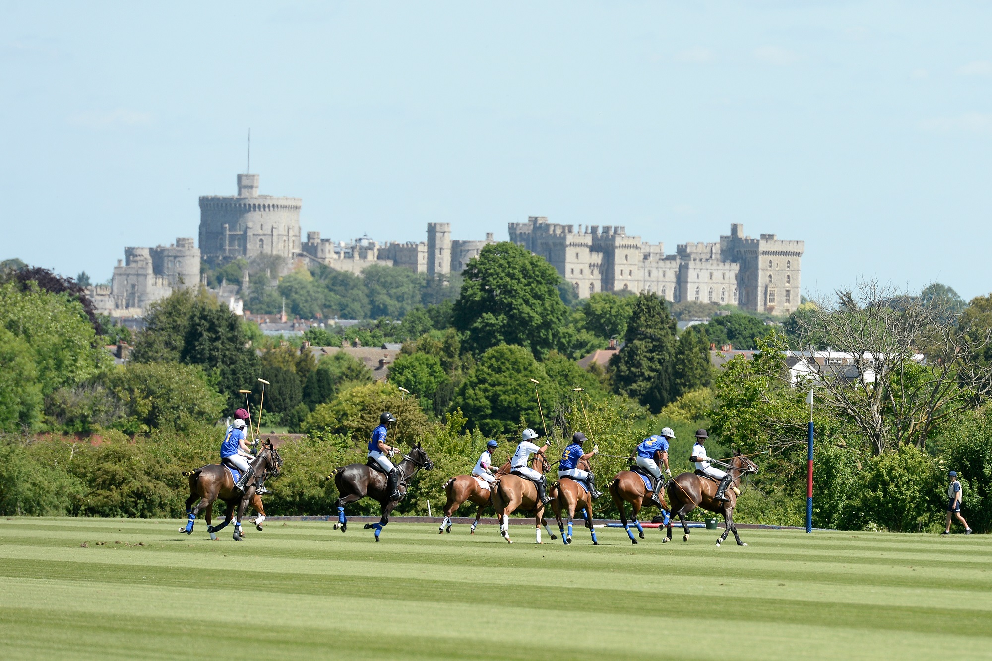 Guard's Polo Club. Polo players on their horses with Windsor Castle in the background.