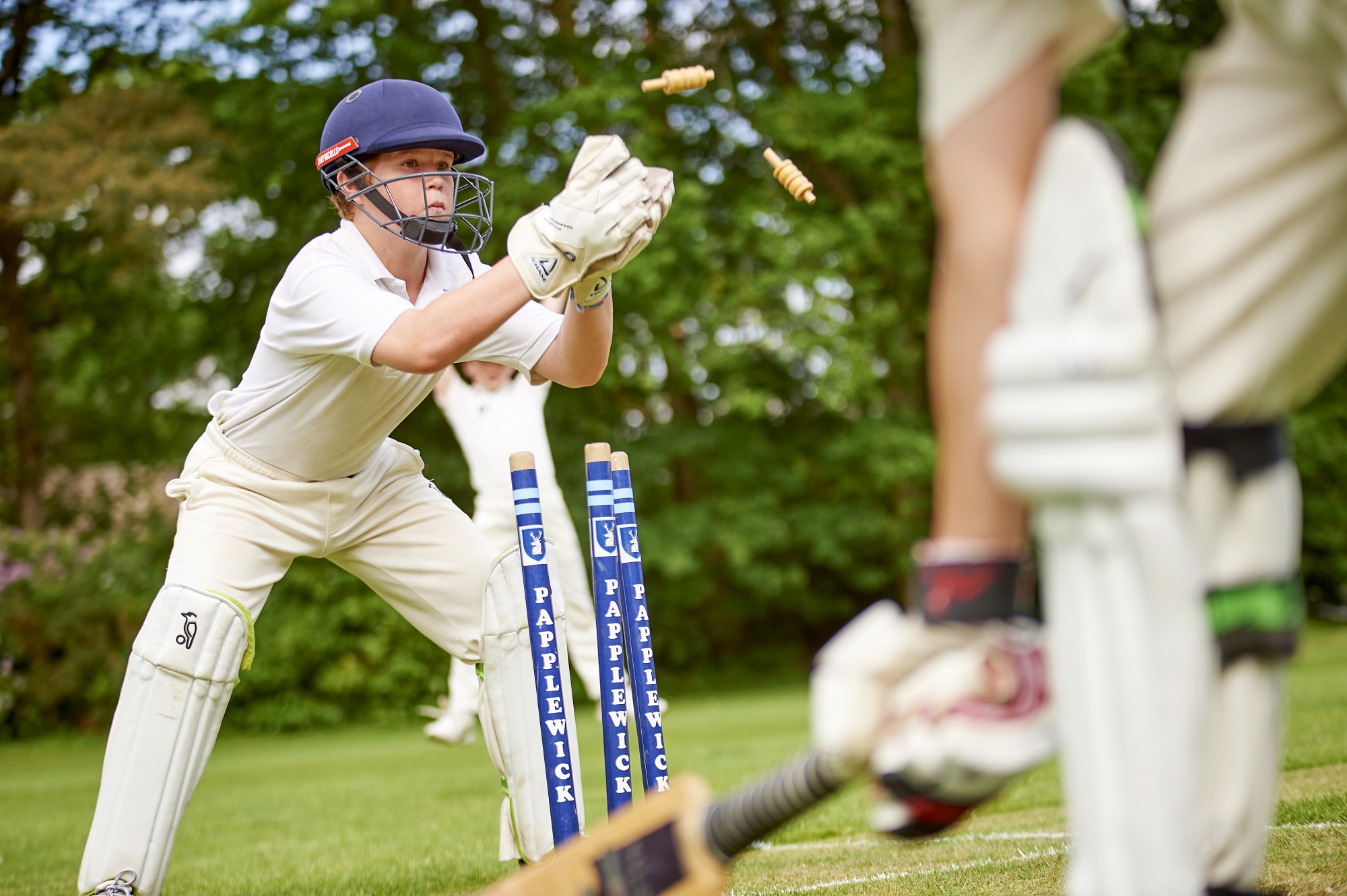Young person playing cricket.