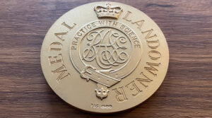 Bledisloe Gold Medal on an Oak background.