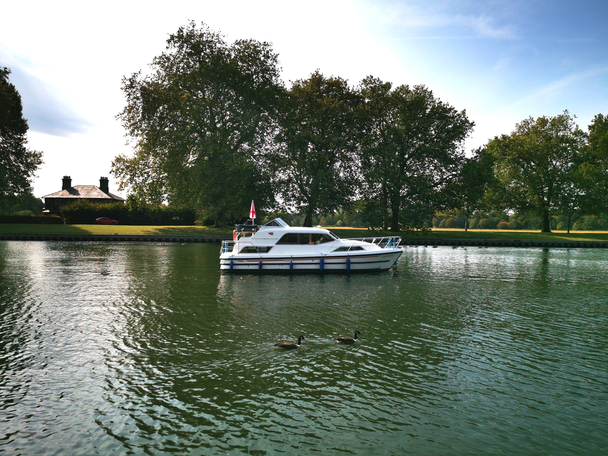 Kris Cruisers Lady Natalia boat on water with trees in the background.