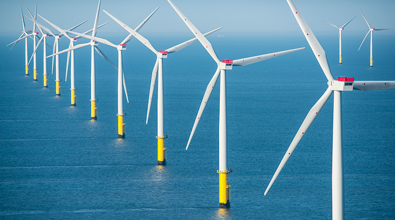 A row of off-shore wind turbines.