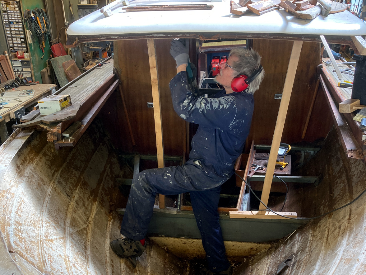 Person working on a boat at Tom Jones Boatyard.