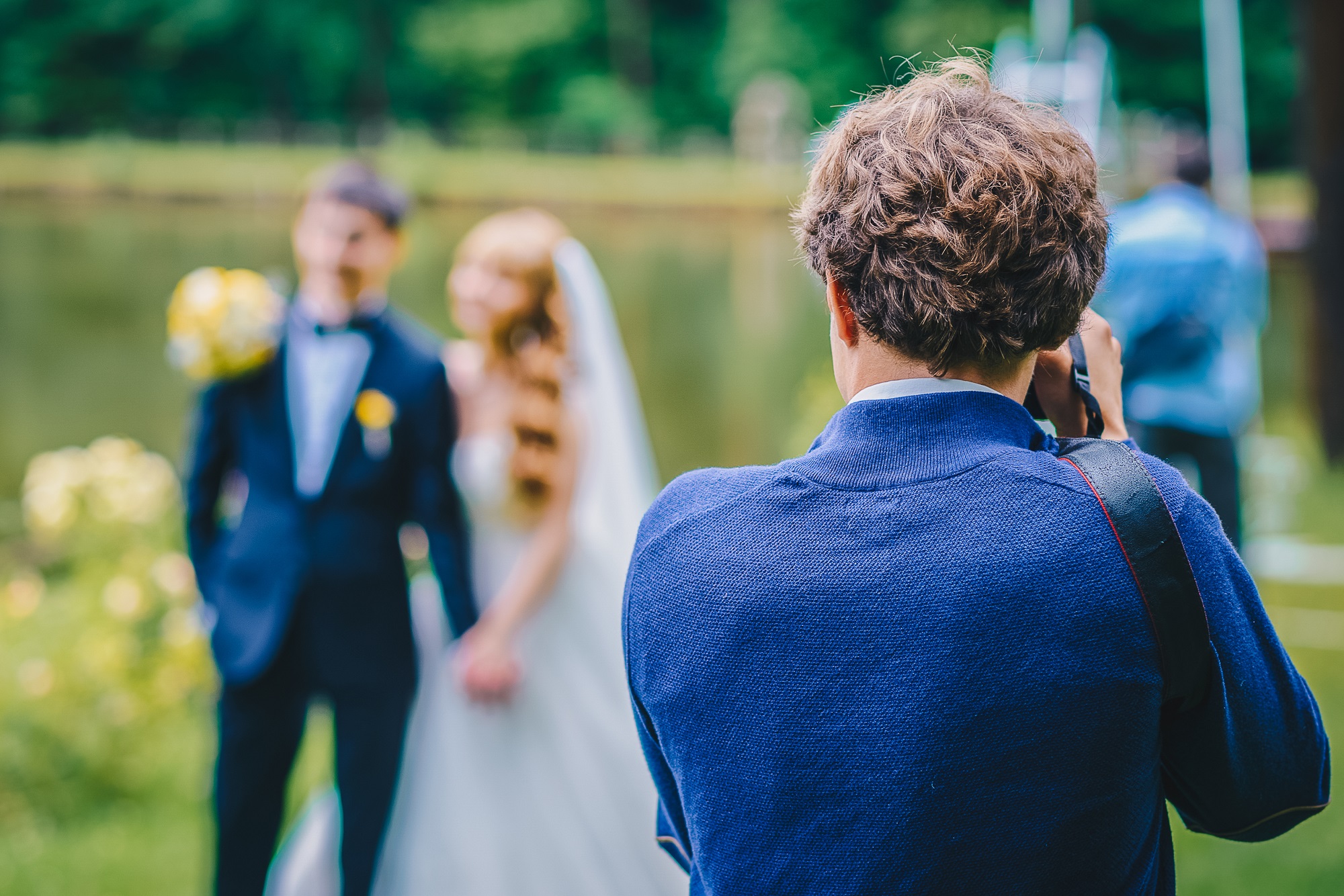 Photographer taking a picture of a wedding couple.
