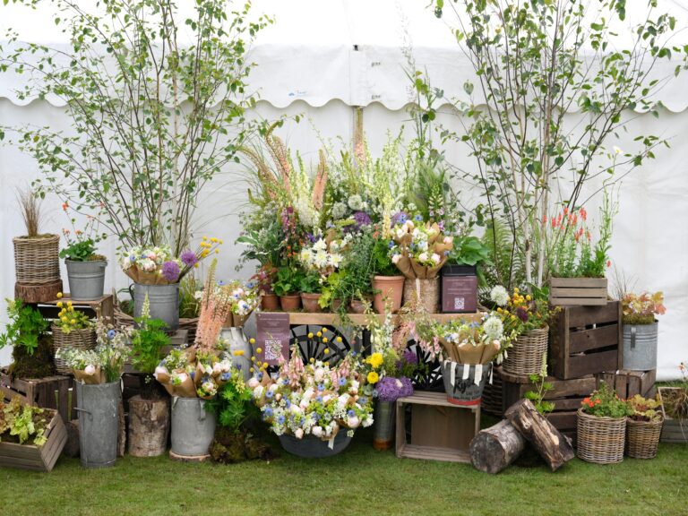 A range of flowers and bouquets presented in metal urns, buckets, wooden boxes and terracotta pots.