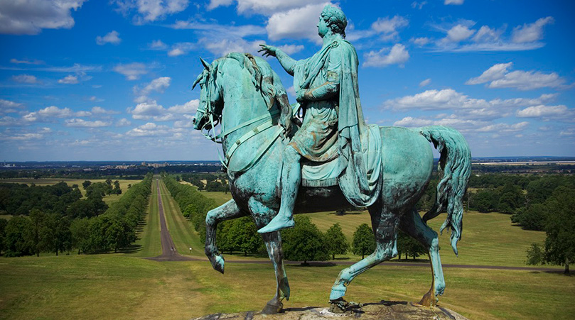 A close up of The Copper Horse statue looking down The Long Walk to Windsor Castle.