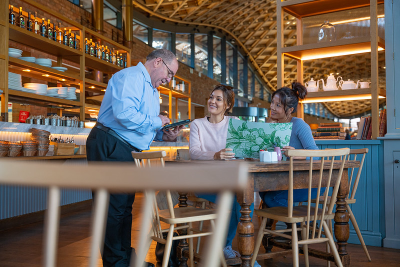 Couple being served in The Savill Garden Kitchen. 