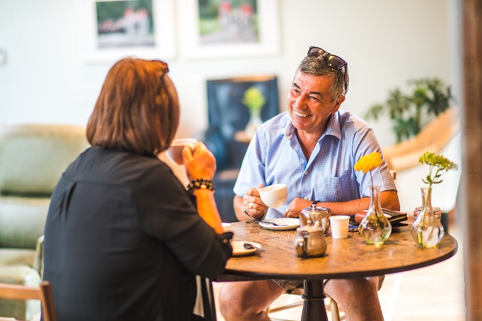 Couple sitting at a table drinking tea in the Gallery Café. 