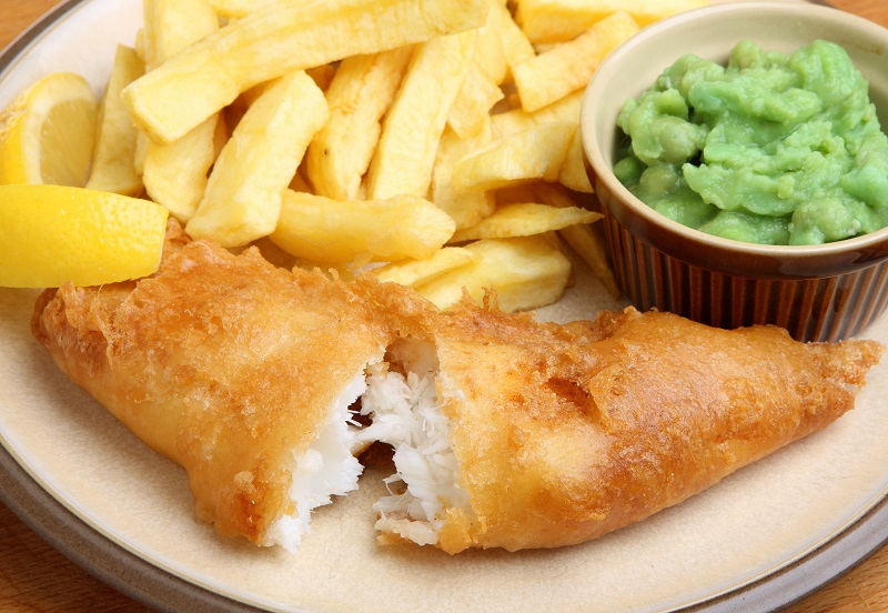 Fish, Chips and Peas with a slice of Lemon.