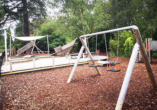 A wooden children's swing set