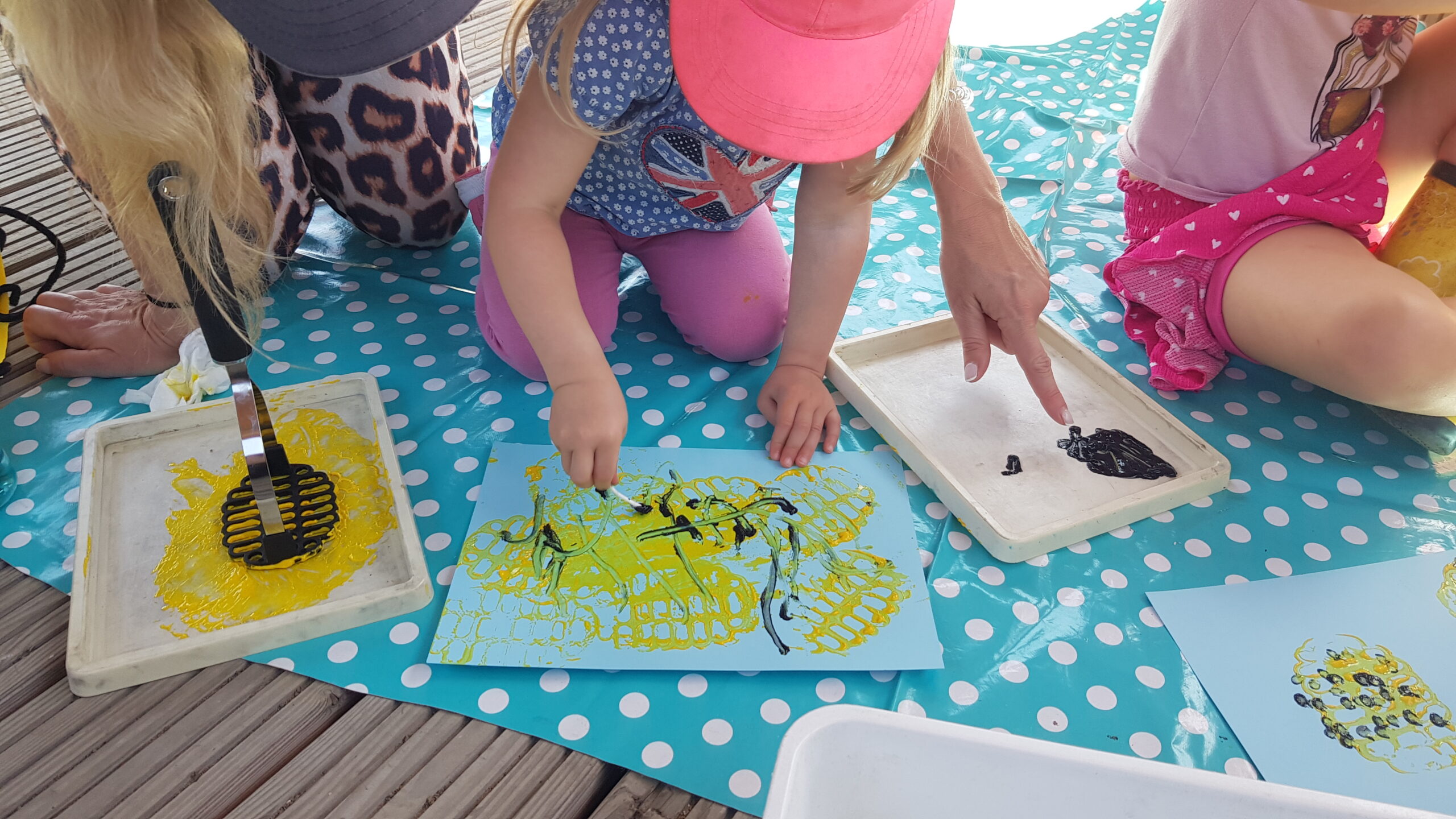 Children on a mat painting.