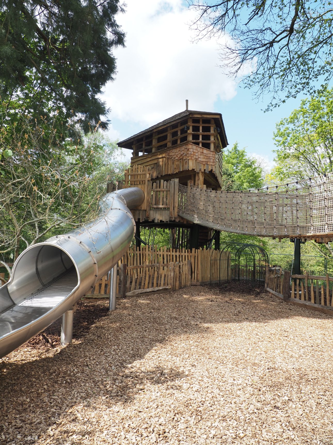 View of a treehouse and slide.