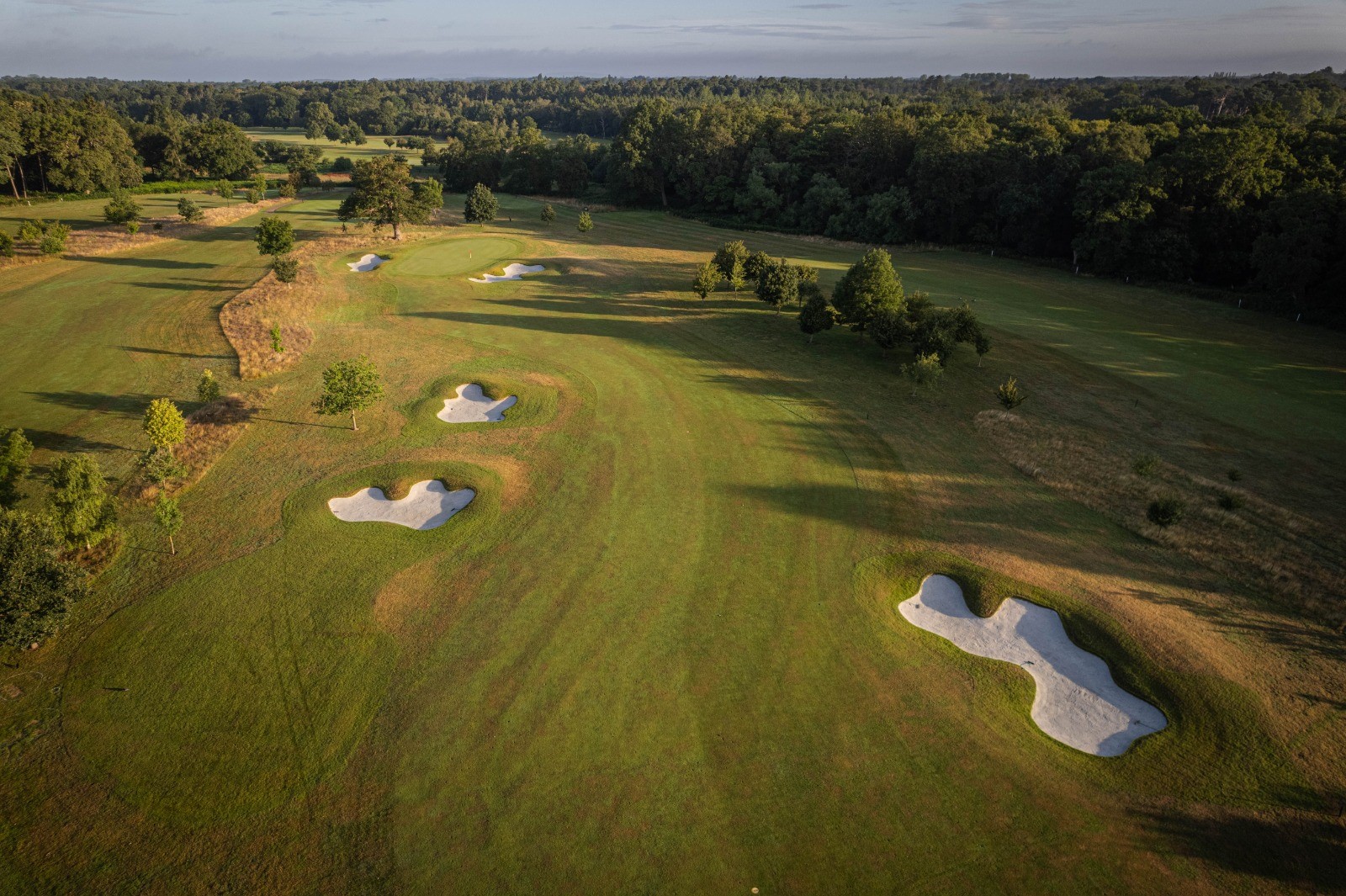 Aerial view of The Royal Ascot Golf Club with bunkers and trees.