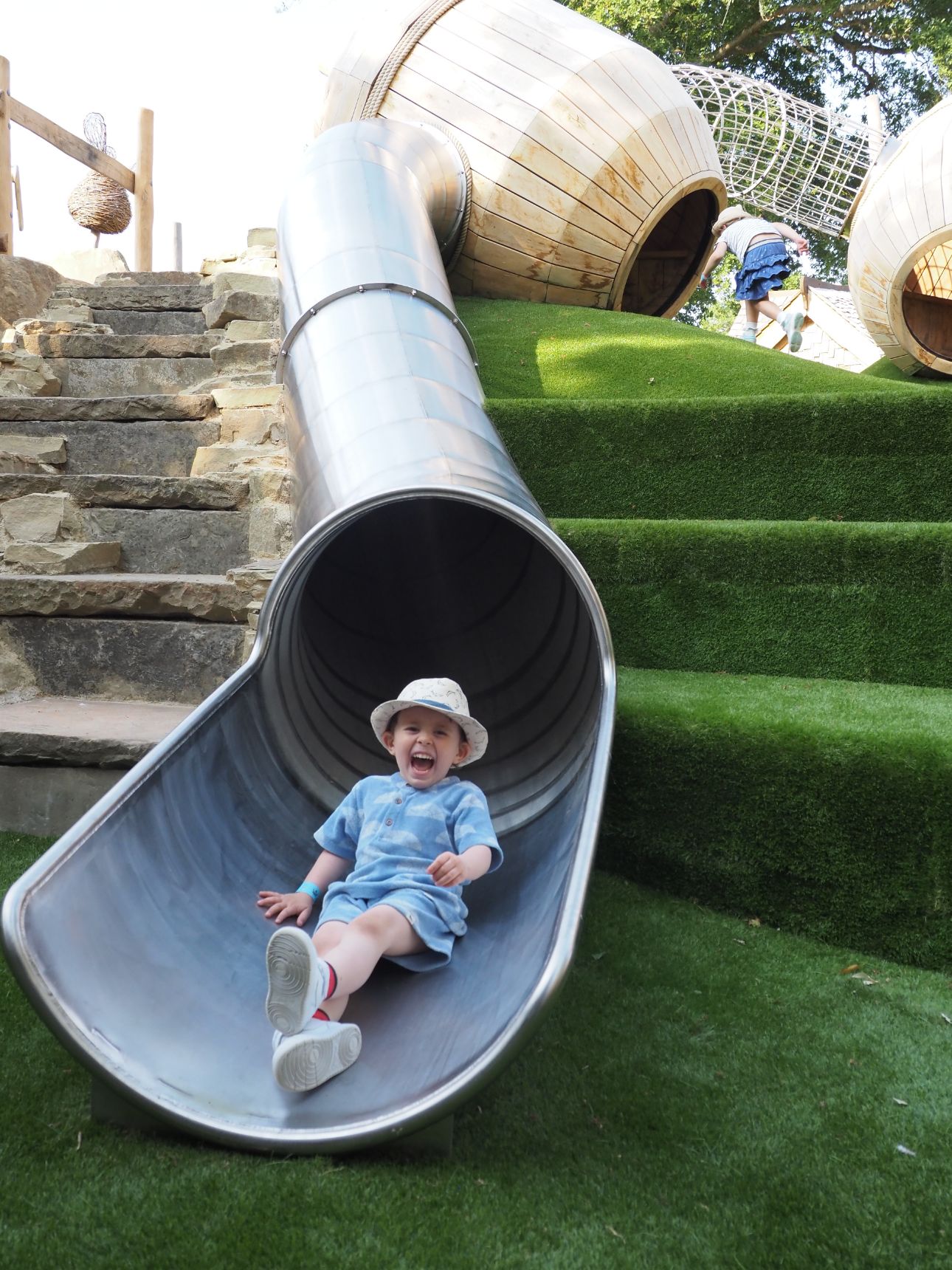 Young child at the bottom of a slide.