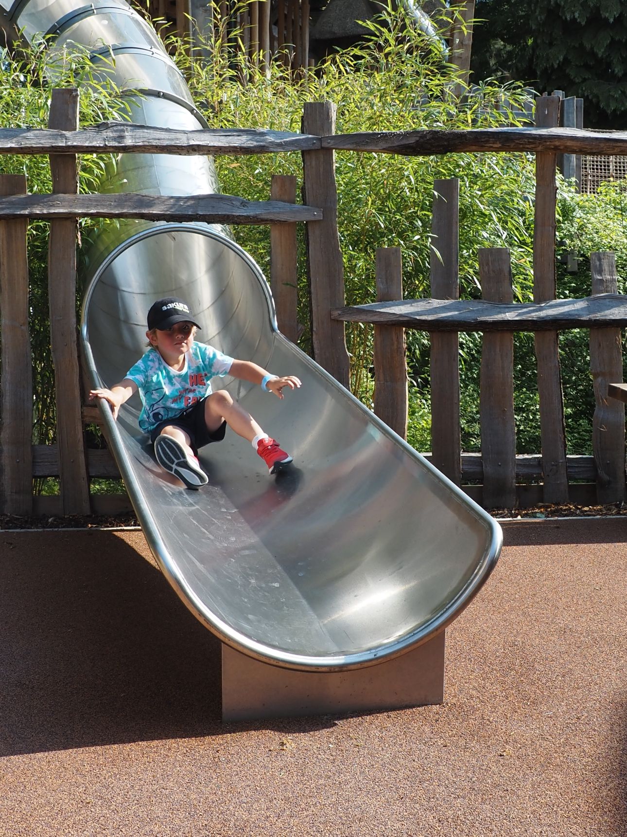 Young child at the bottom of a slide.