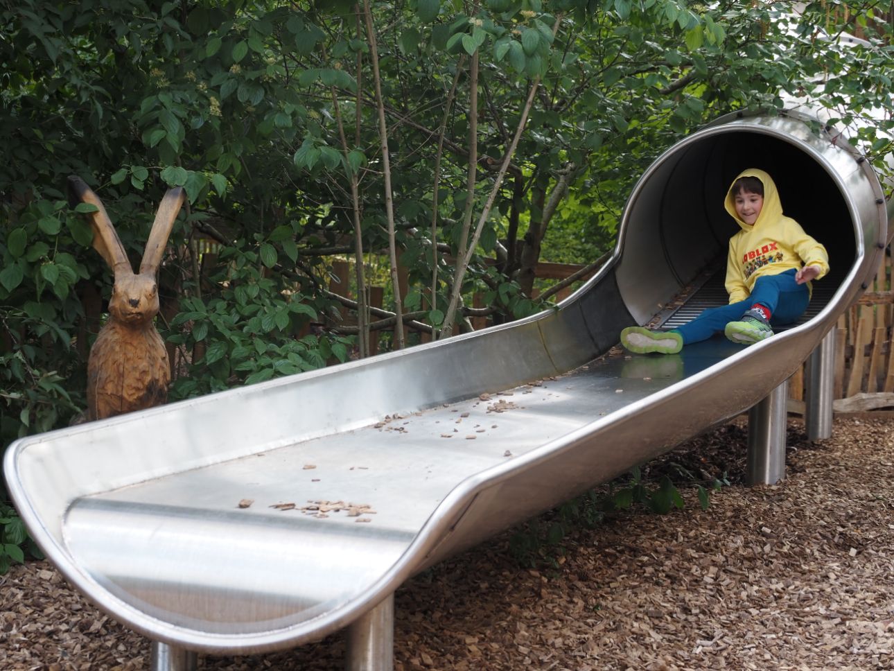 Young child at the bottom of a slide.