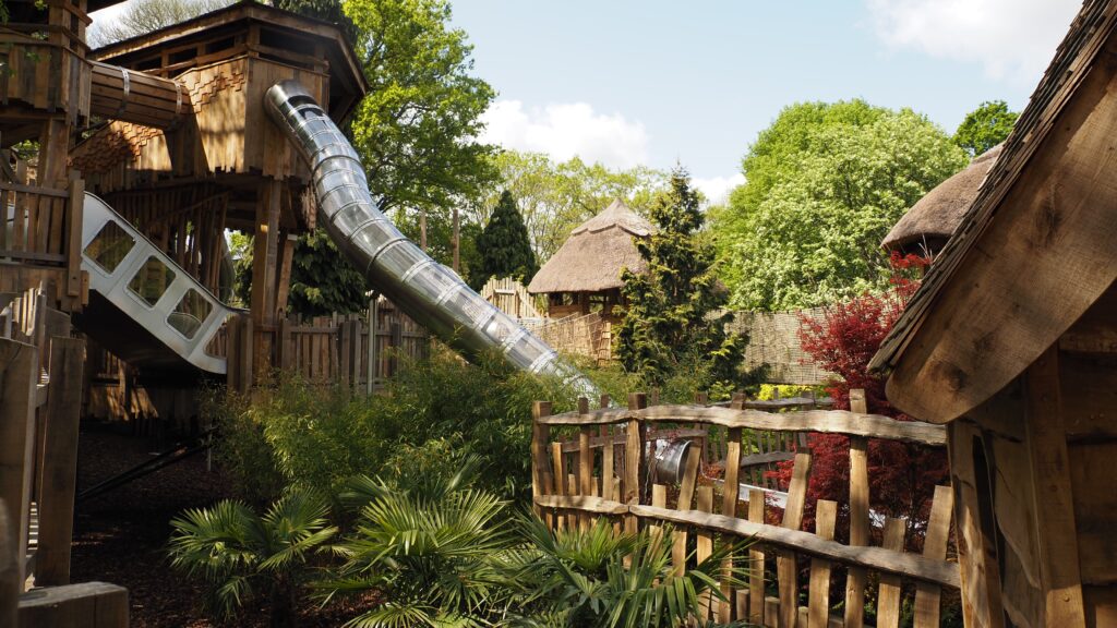 Adventure Play slides including Accessible slide surrounded by greenery.