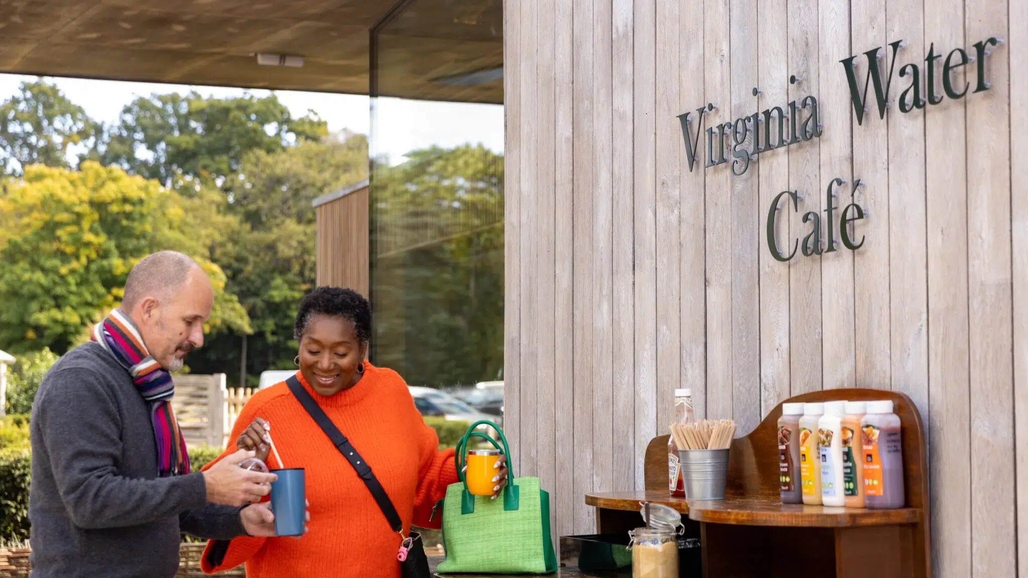 Two adults standing outside the Virginia Water Café.