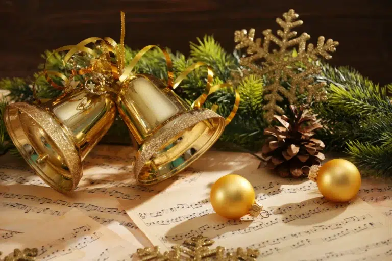 Sheet music with Christmas garland and bells.