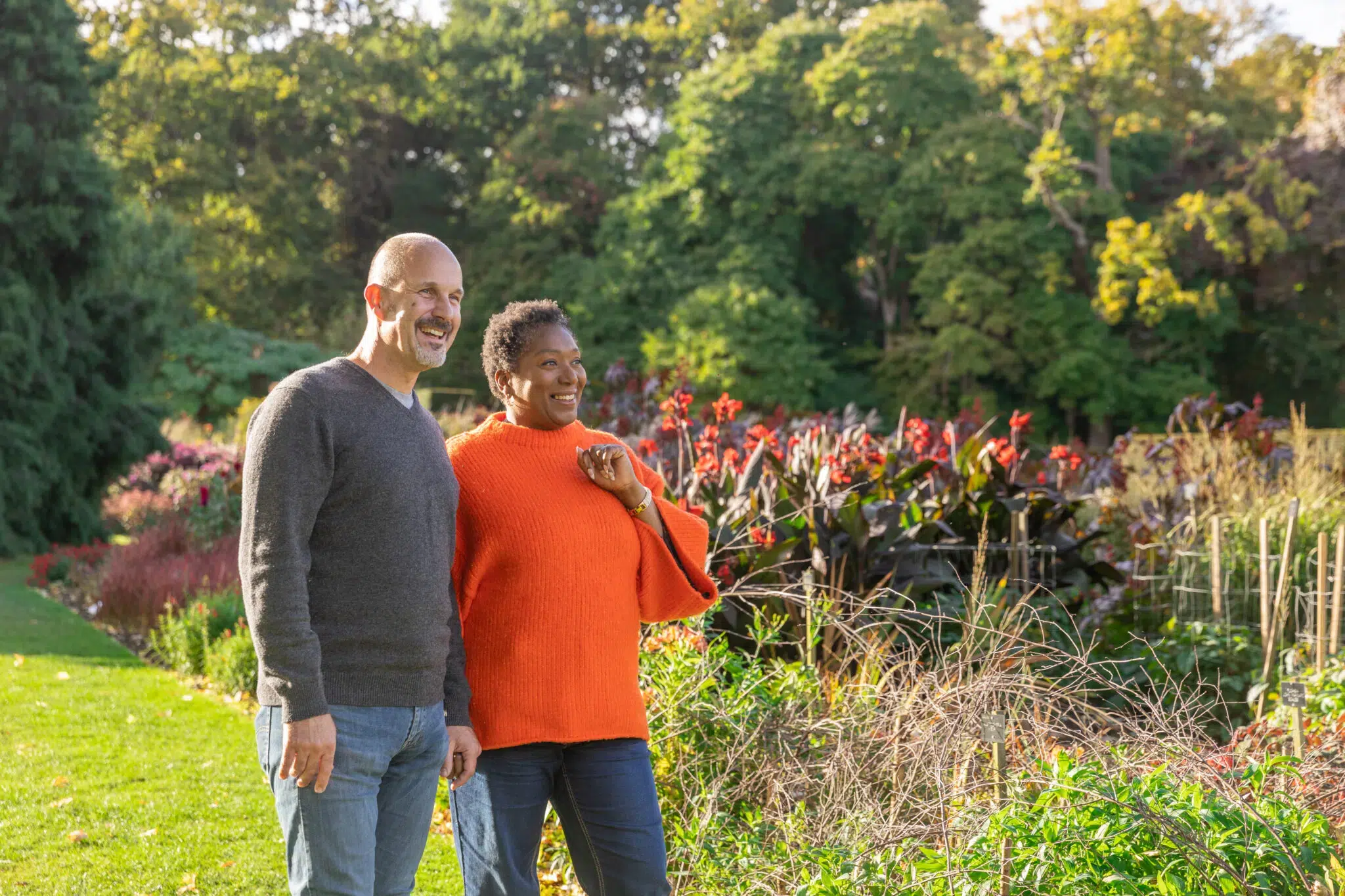 Two adults speaking to a staff member in The Savill Garden Visitor Centre.