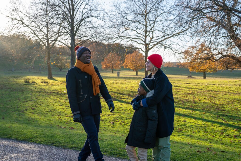 Family from multi-ethnic background in parkland at Windsor Great Park.