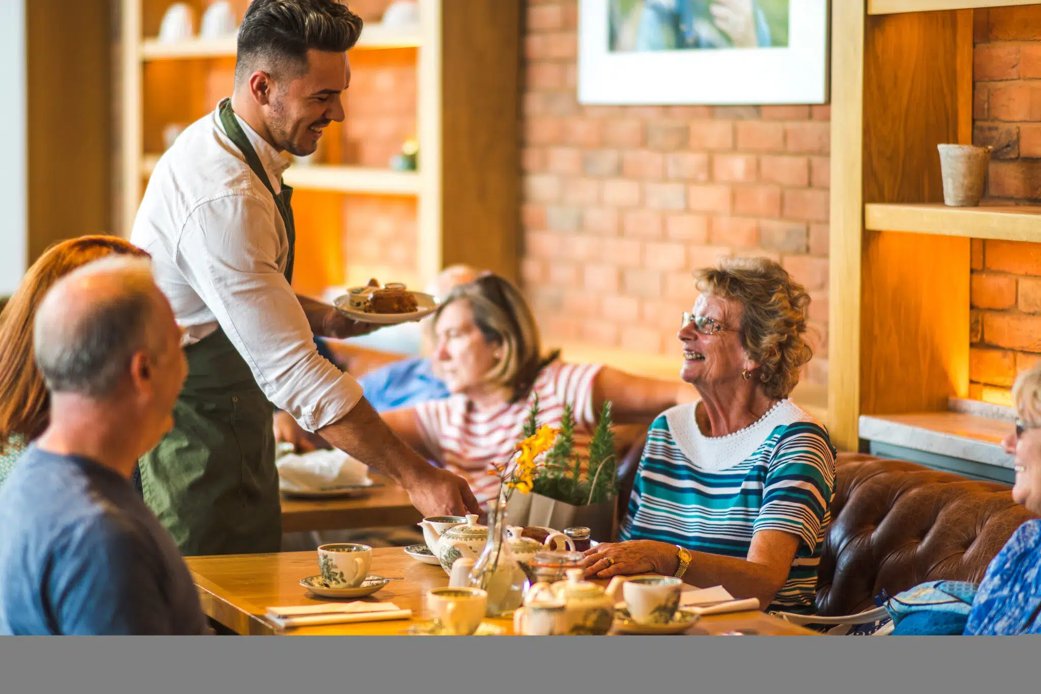 Group of people being served by a waitstaff in The Savill Garden Kitchen.