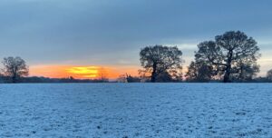A sunrise over a snowy landscape
