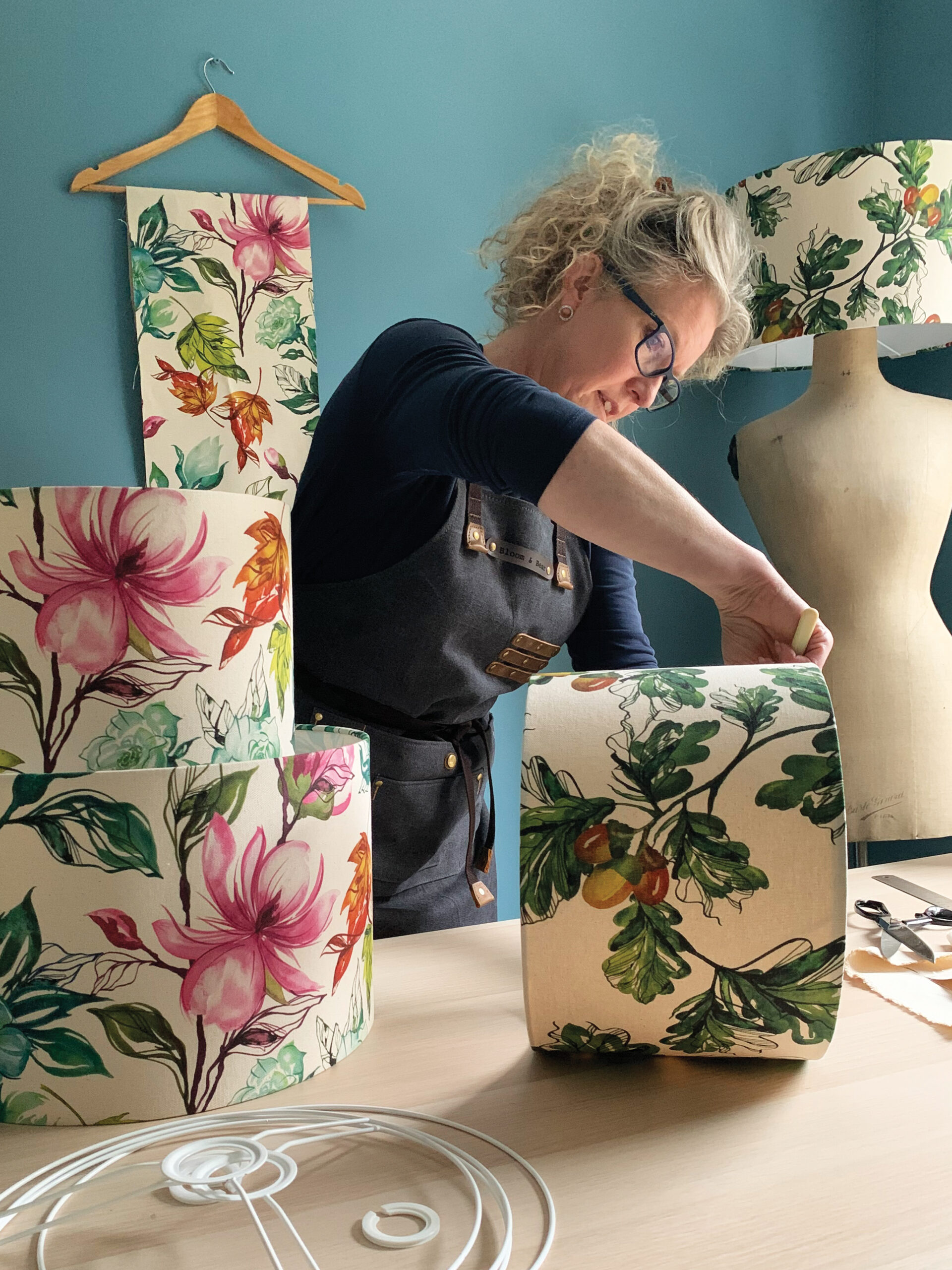 A person making a lampshade from fabric