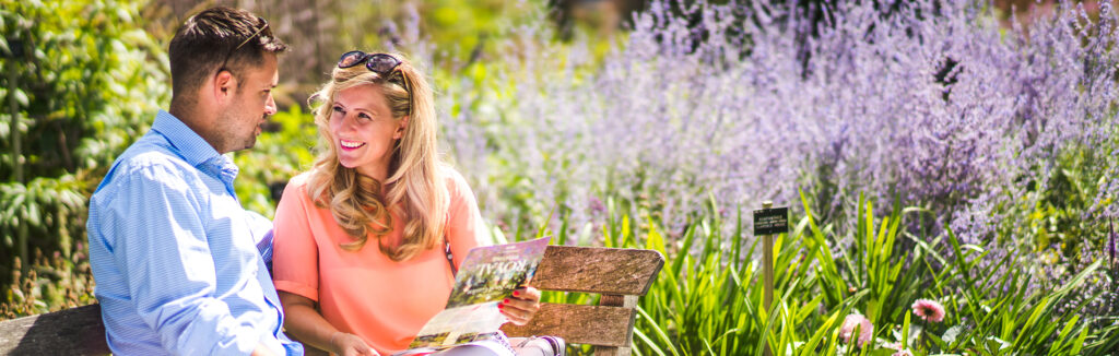 Couple in The Savill Garden sitting on a bench.