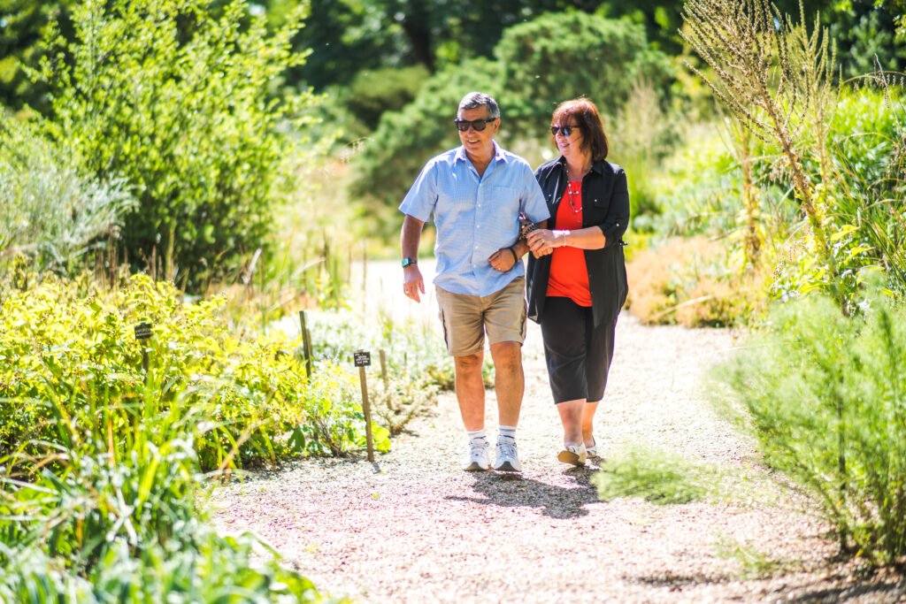 Couple walking in The Savill Garden.