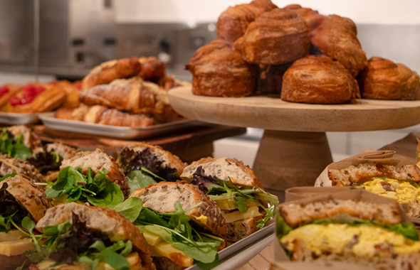 A display of sandwiches and pastries.