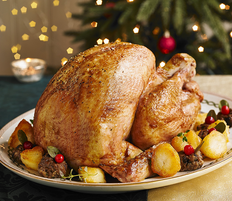 Cooked Turkey on a plate with vegetables. 810 x 700