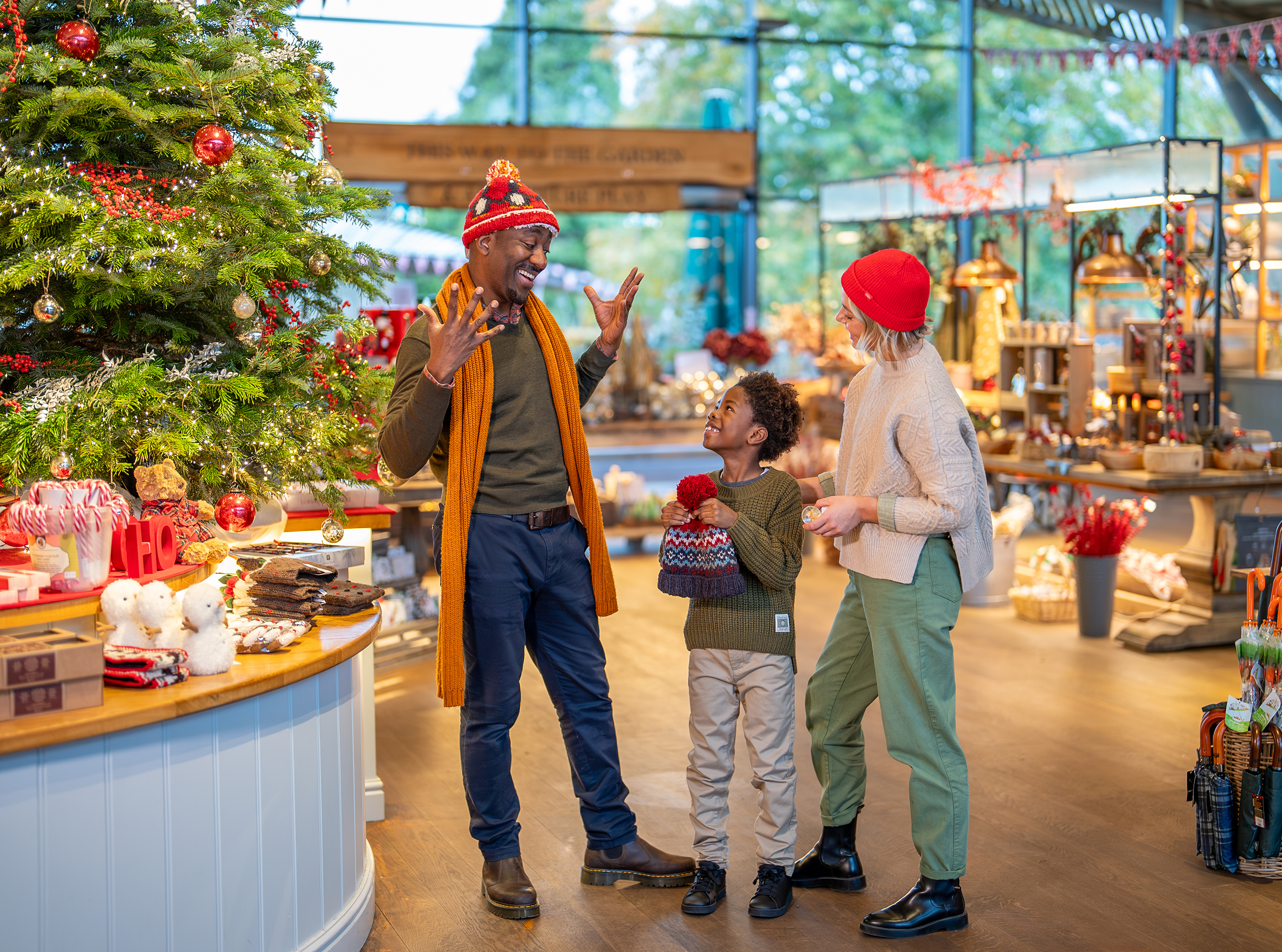 Family from multi ethnic background smiling with each other in the gift shop.