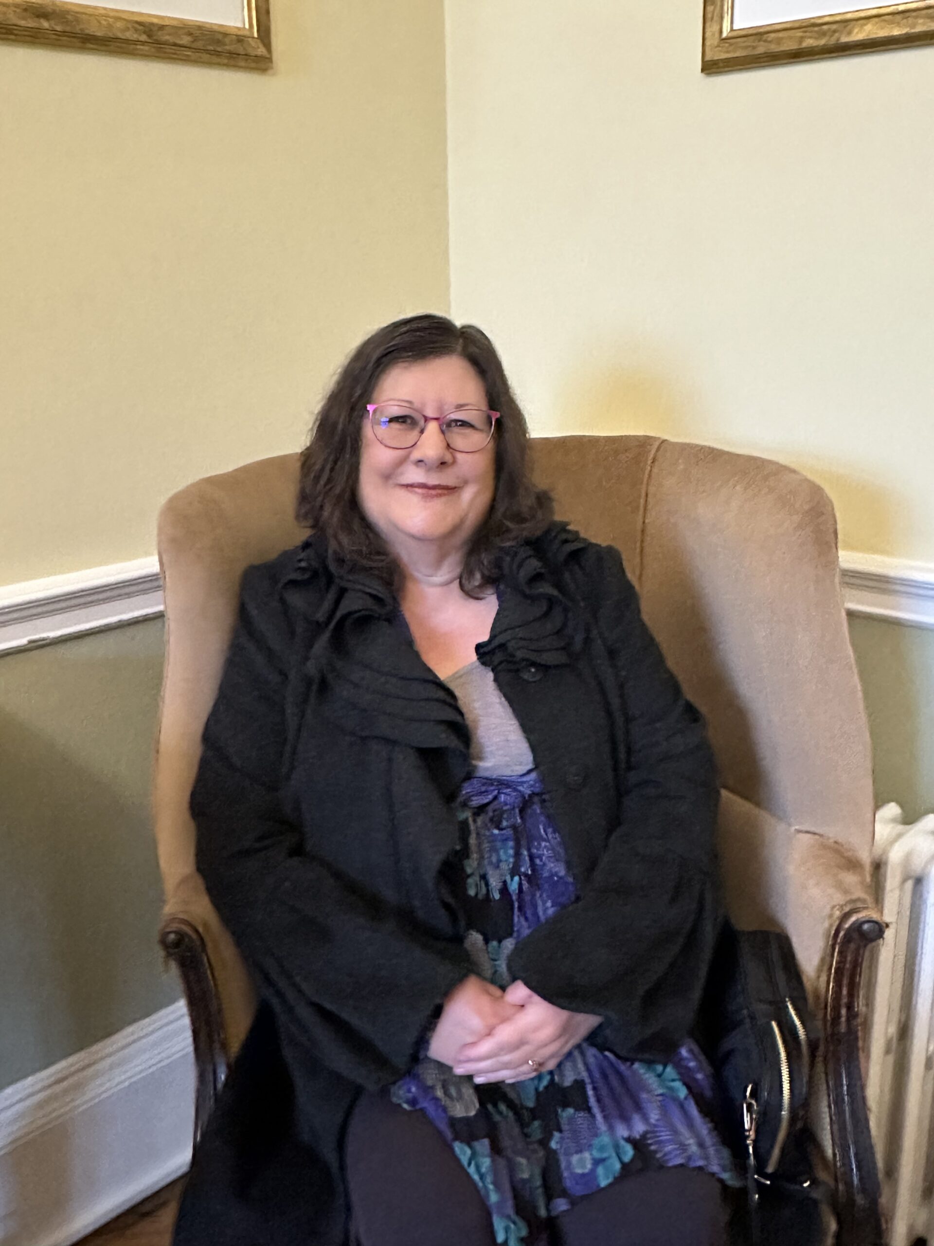 A person sitting on an armchair.