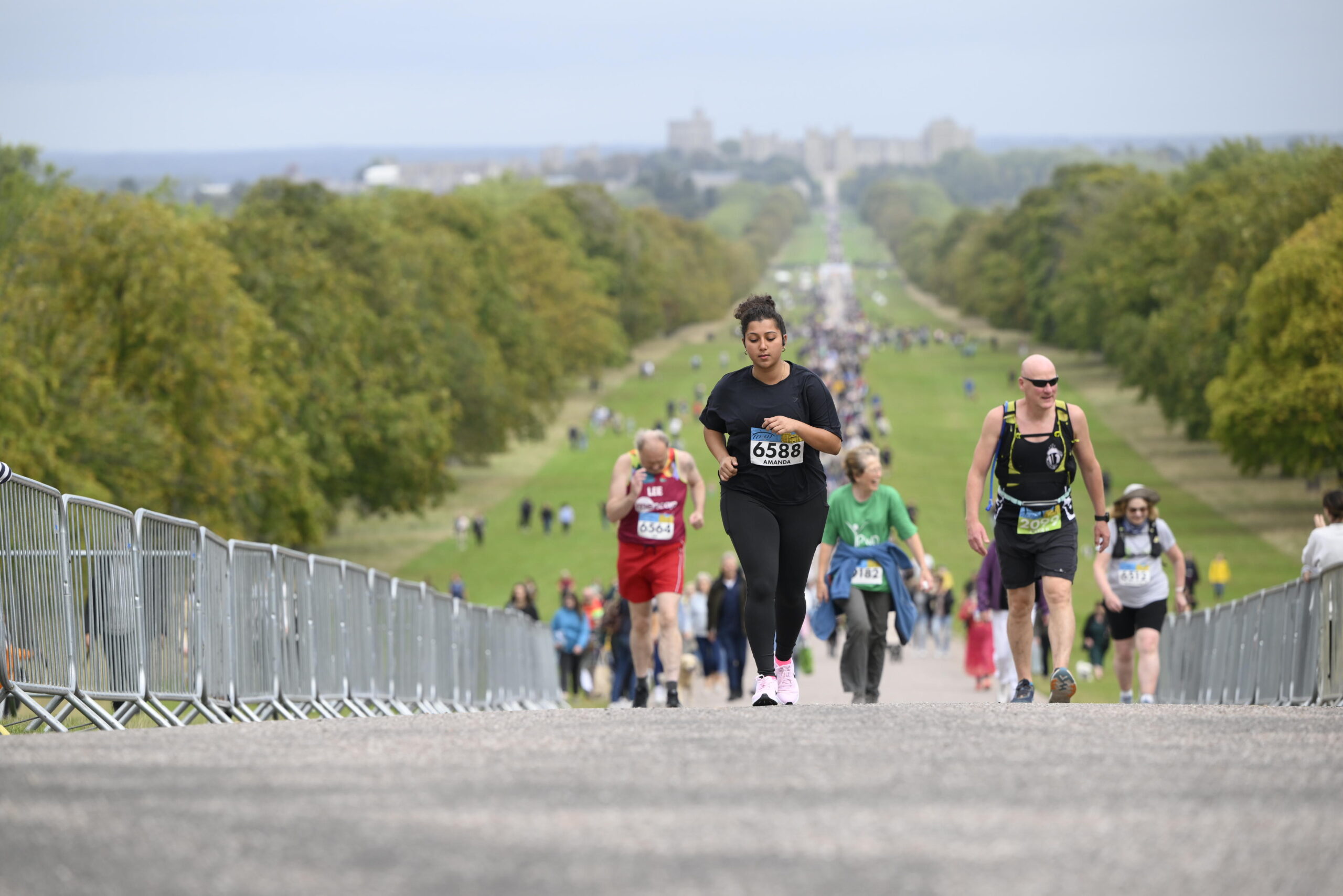 Runners on The Long Walk with Windsor Castle behind.