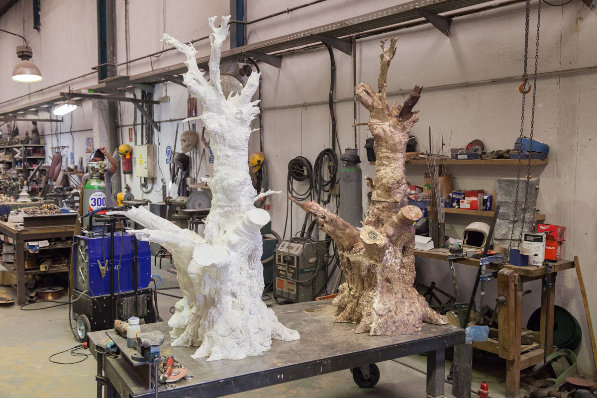A comparison between the resin oak tree and the final bronze sculpture.