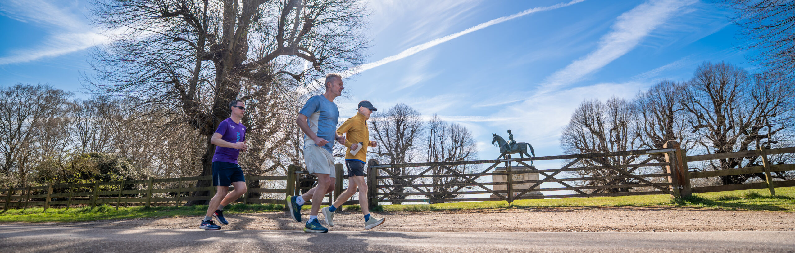 Male running in the foreground towards Windsor Castle in the Background