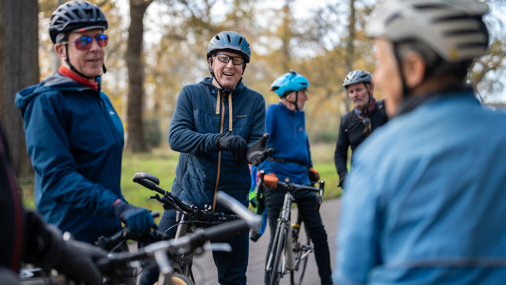 Four adults on push bikes.