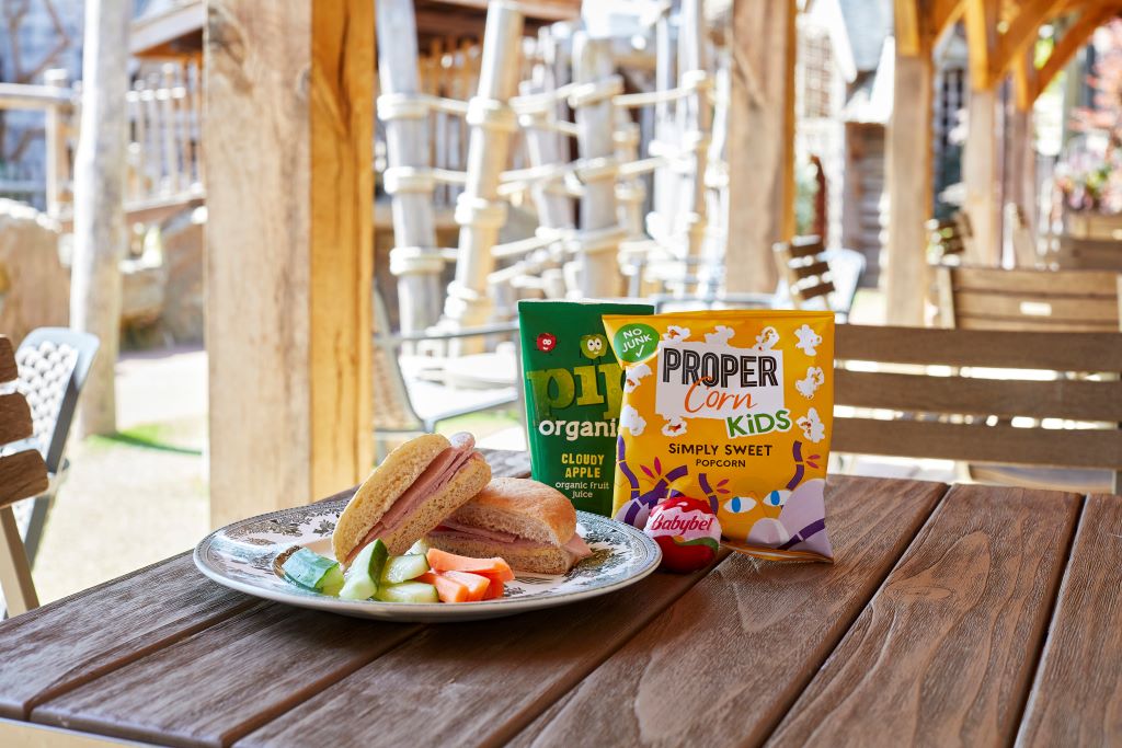 Ham roll with Cucumber, Carrots, Organic Apple Juice, Popcorn and Cheese.