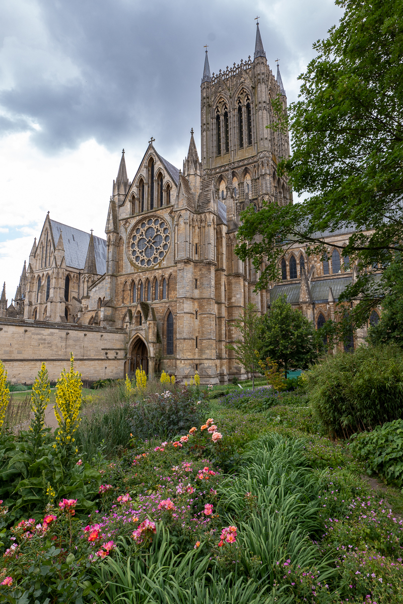 A garden border with Lincoln Cathedral reaching to the sky in  the background.