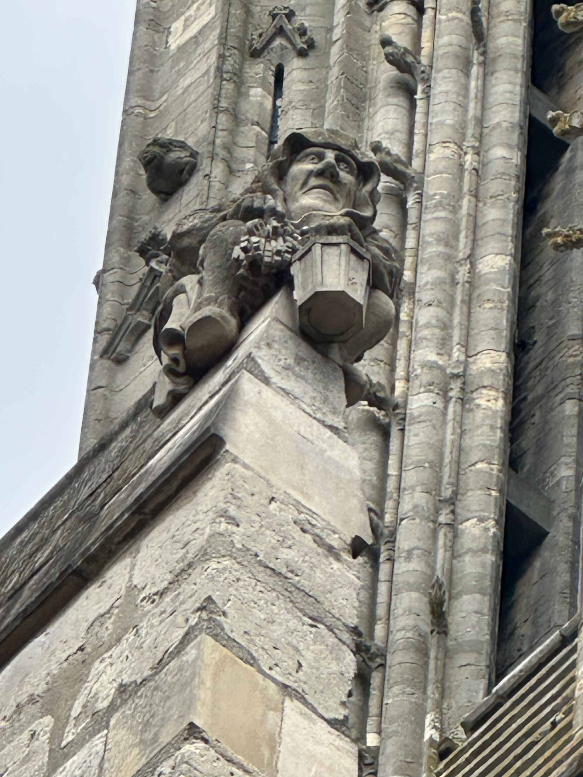 A gargoyle on Lincoln Cathedral holding a stack of keys.