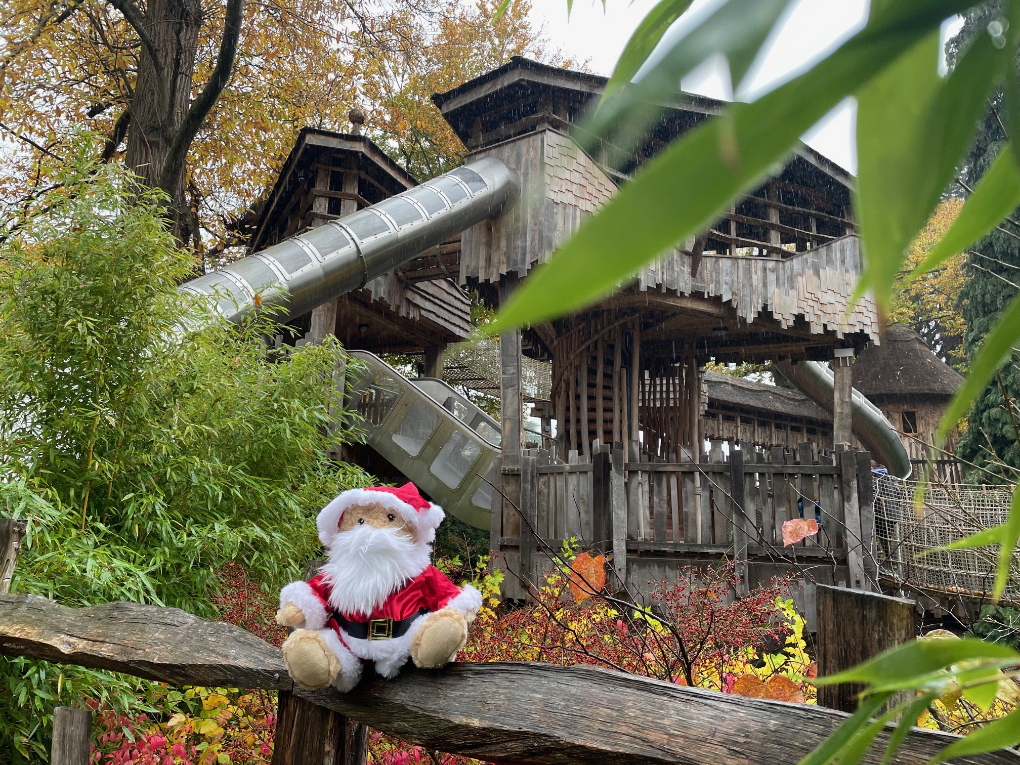 Adventure Play Bear wearing a Father Christmas outfit with Adventure Play in the background.