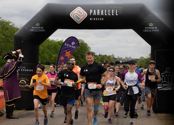 People running through an inflatable arch on The Long Walk