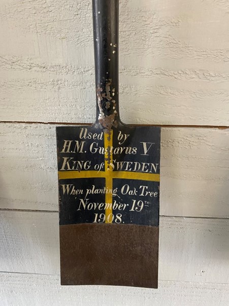 A spade inscribed with the words 'Used by H.M. Gustavus V King of Sweden When planting Oak Tree November 19th 1908. '