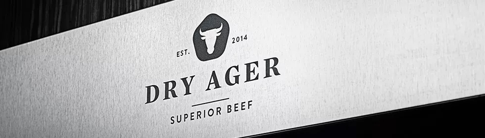 Dry-Ager Fridge brand logo on a stainless steel fridge door.
