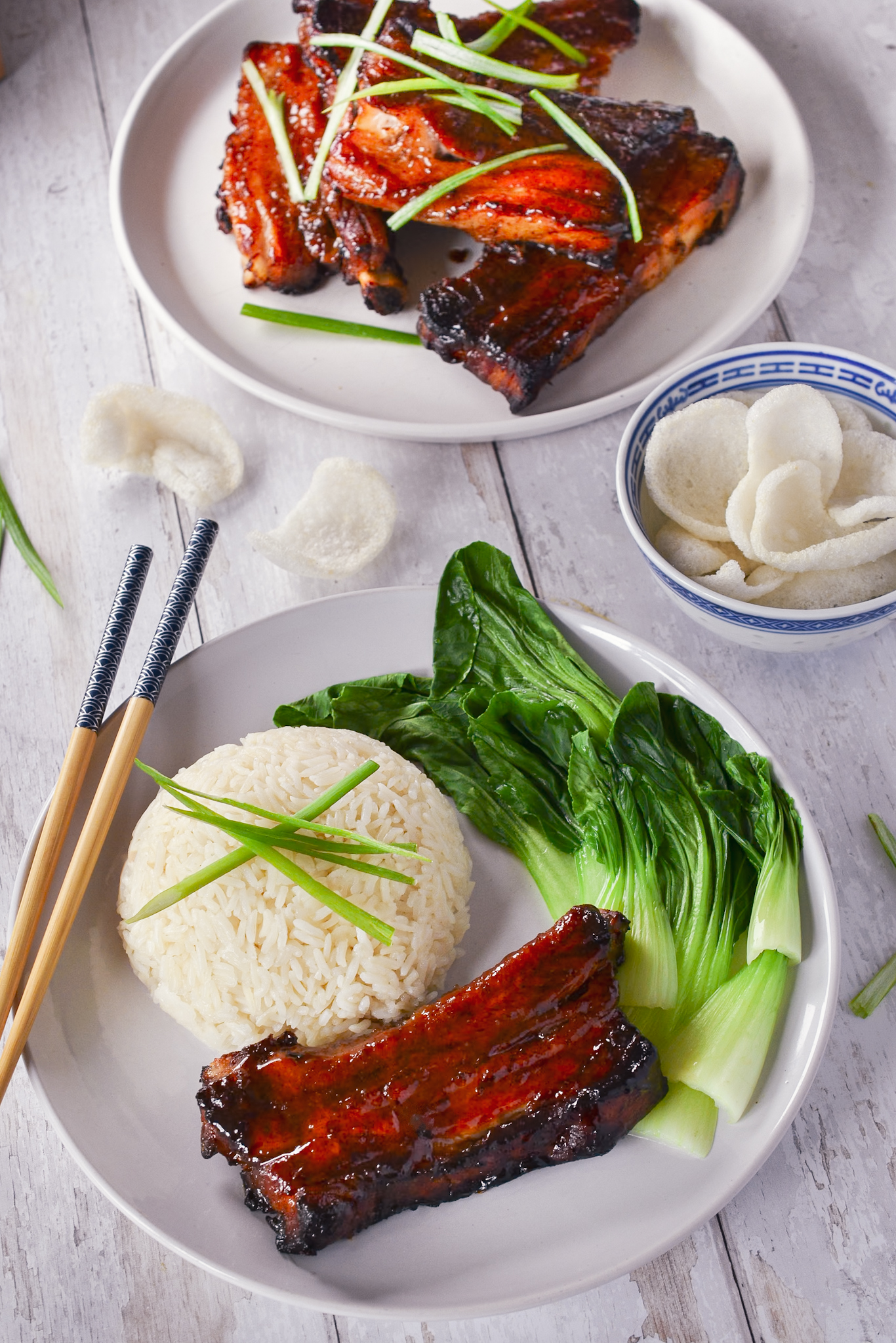 Char Siu Pork Ribs with Jasmin Rice, Pak Choi, garnished with sliced Spring Onions with a dish of Prawn Crackers.