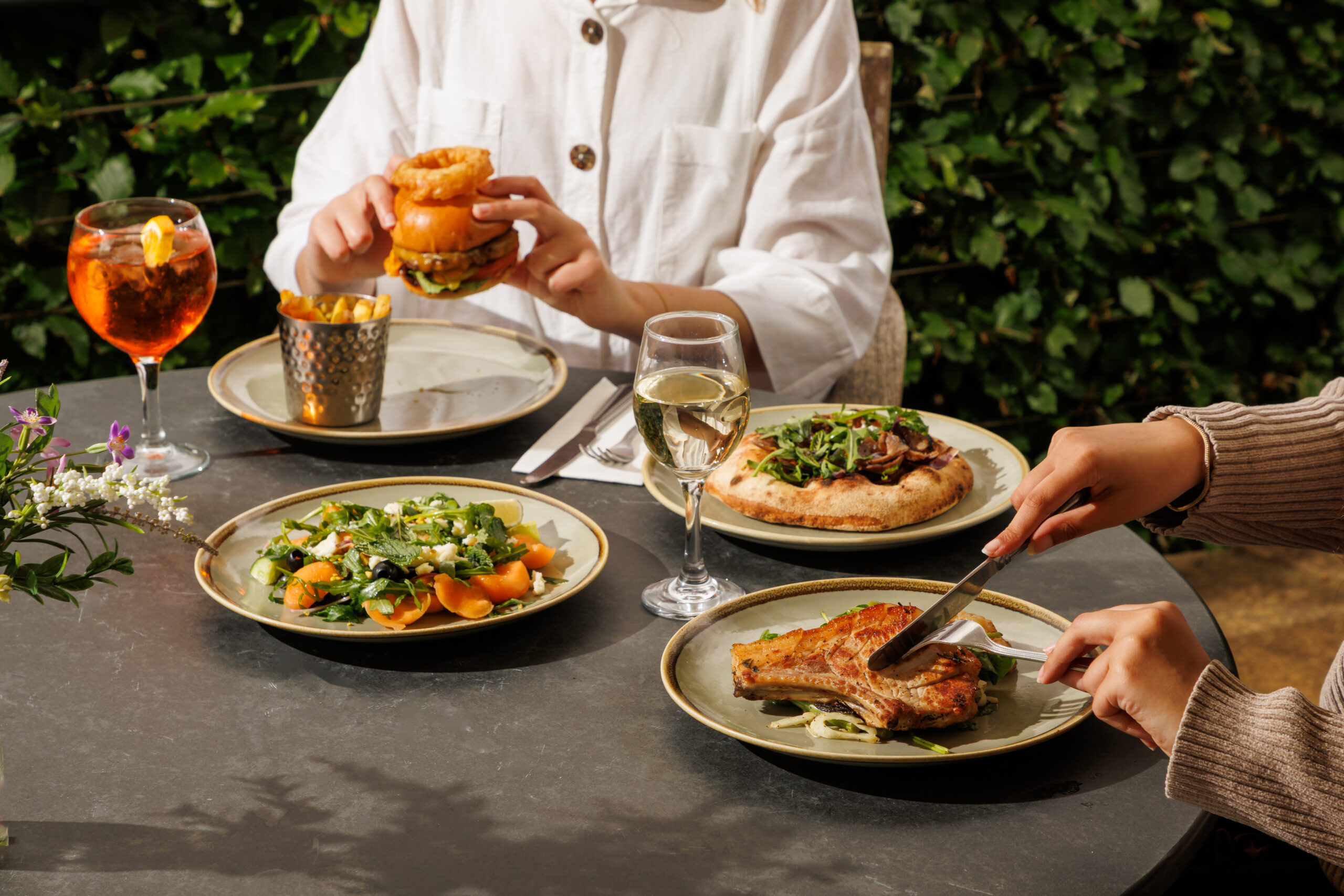 Two adults eating lunch on The Savill Garden Kitchen Terrace.